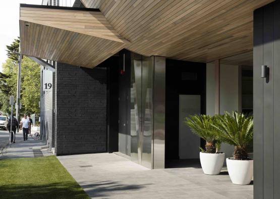 a building with plants on the front porch