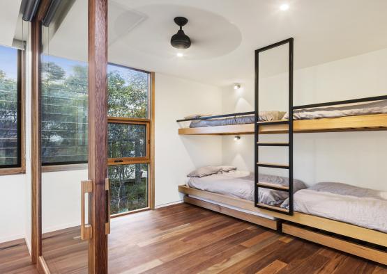a room with bunk beds and a wood floor