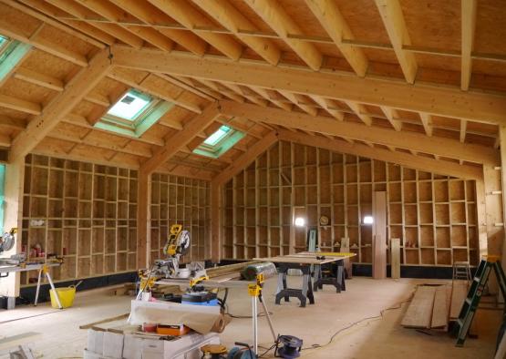 a room with wood beams and a saw