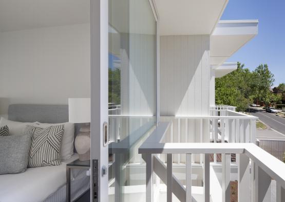 a white balcony with glass doors