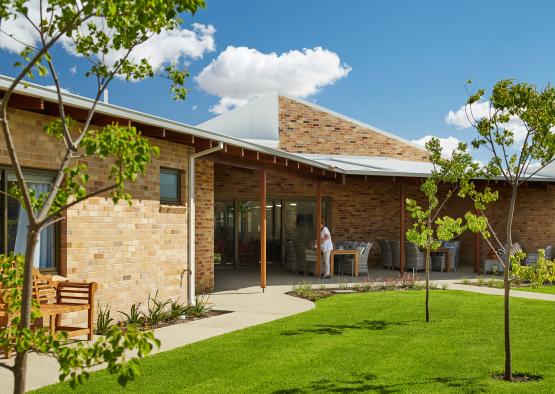 a building with a lawn and a bench