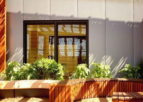 a building with a bench and plants