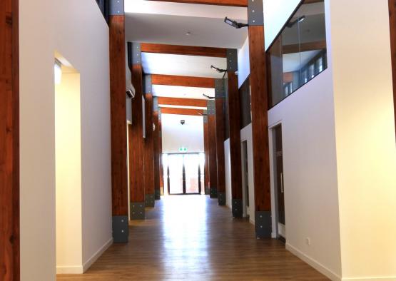 a hallway with wood beams and a wood floor