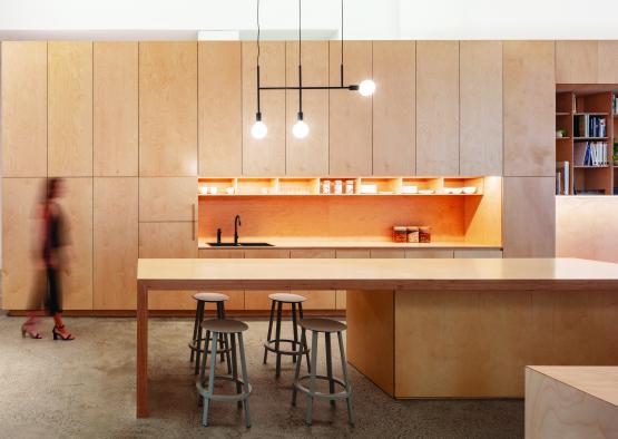 a kitchen with a table and stools