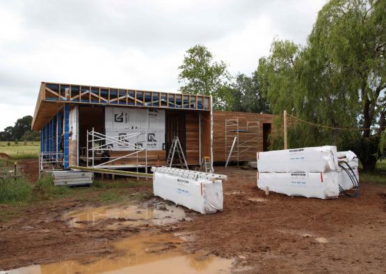 a building under construction with scaffolding and white blocks