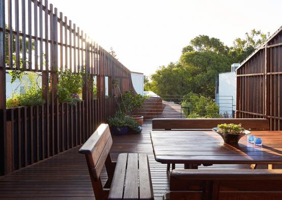 a wooden deck with a table and benches