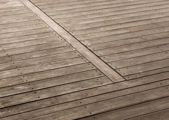 a wooden deck with a cross between the boards