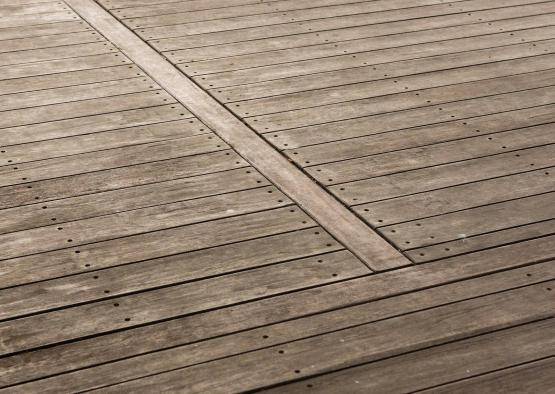 a wooden deck with a cross between the boards