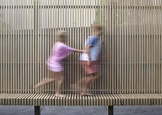 a couple of people walking on a bench