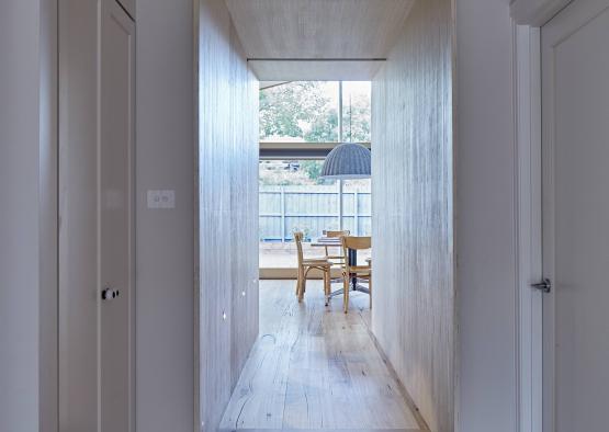 a hallway with a table and chairs