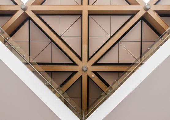 a triangular ceiling with glass railings