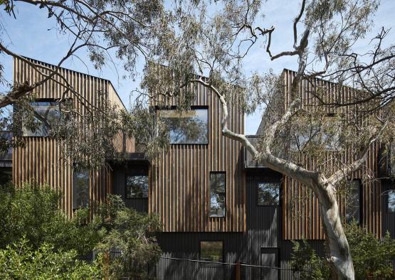 a building with trees and a fence