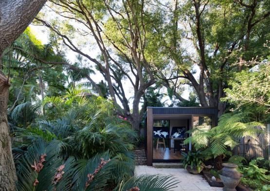 a small building surrounded by trees