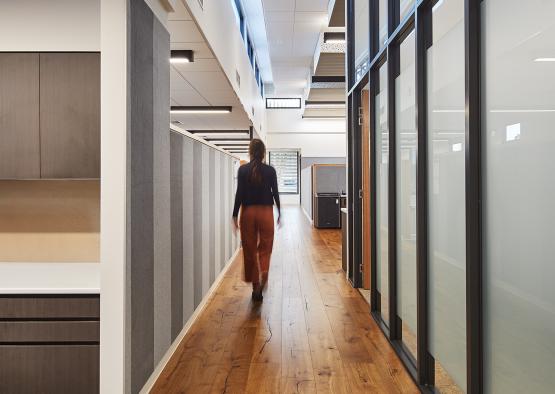 a woman walking down a hallway