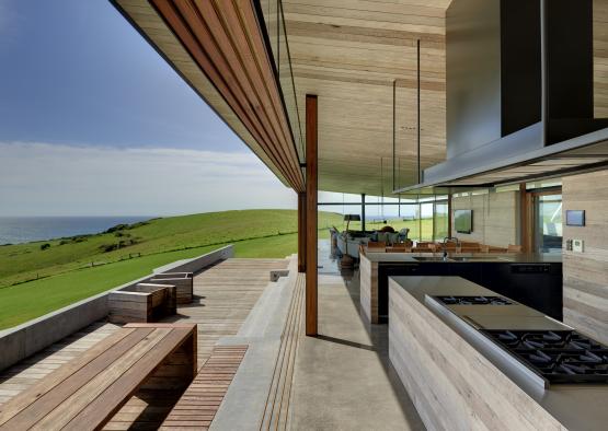 a large outdoor kitchen with a view of the ocean
