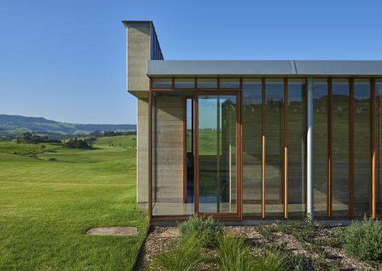 a building with glass doors and a grassy field