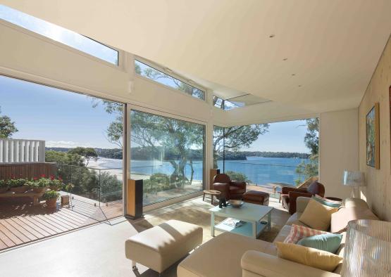 a living room with large windows and a view of water