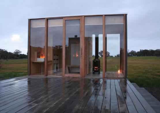 a glass building with a wood deck