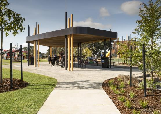 a structure with a wooden structure and people around it