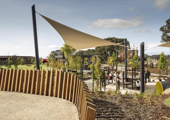 a playground with a shade sail