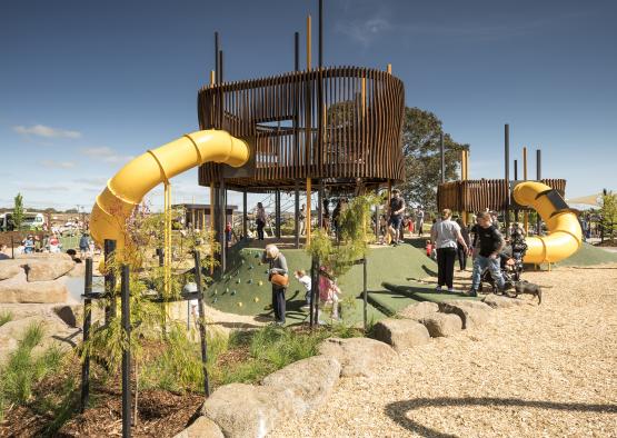a playground with a slide and people