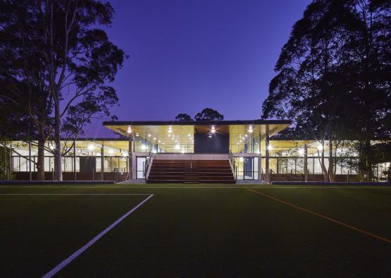 a building with a roof and stairs leading to a football field