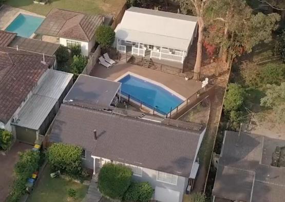 a house with a pool and a car in the back