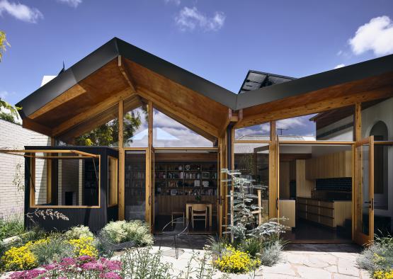 a house with a garden and a glass wall