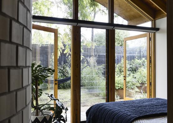 a bedroom with a window and a fan