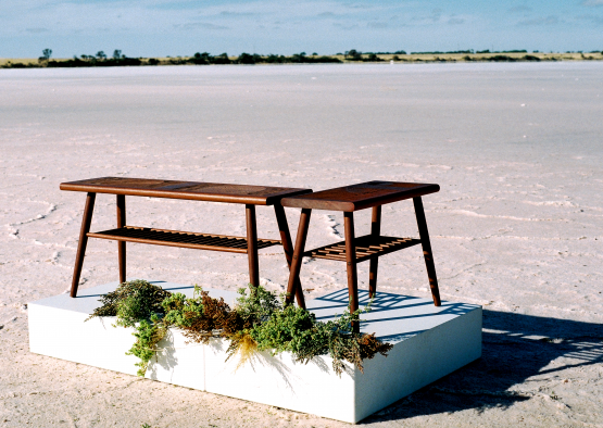 a bench and table on a white square box