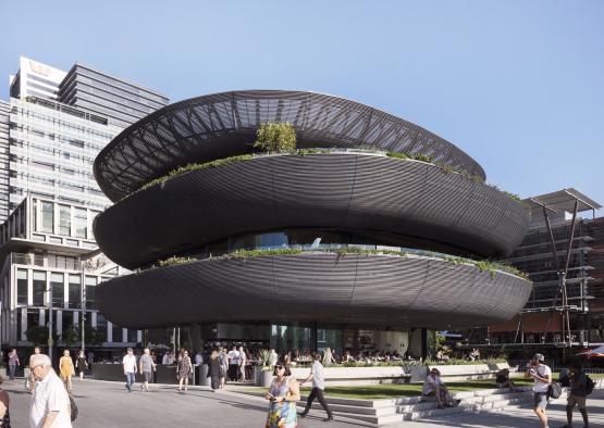 a building with a circular structure with people walking around