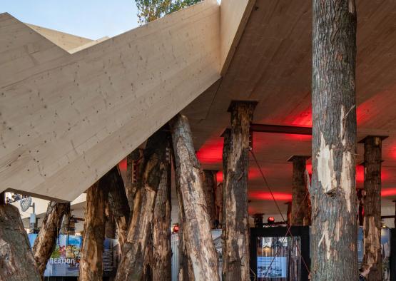 a building with wooden pillars and a red light