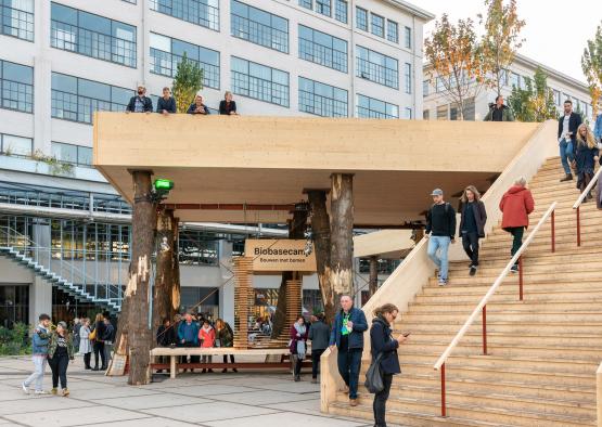 a group of people walking up stairs in front of a building