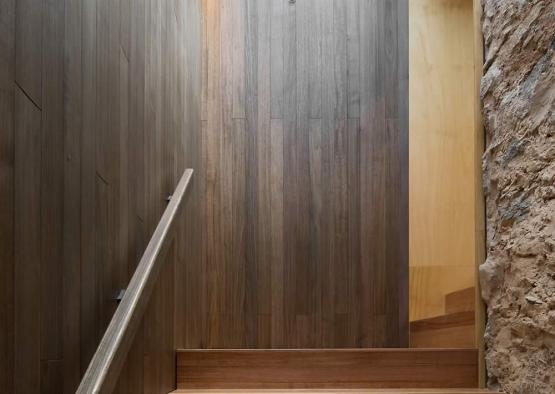 a wood staircase with a handrail