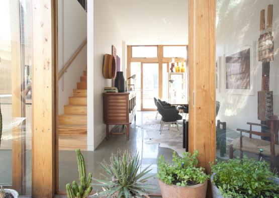 a room with a wood staircase and a wood cabinet