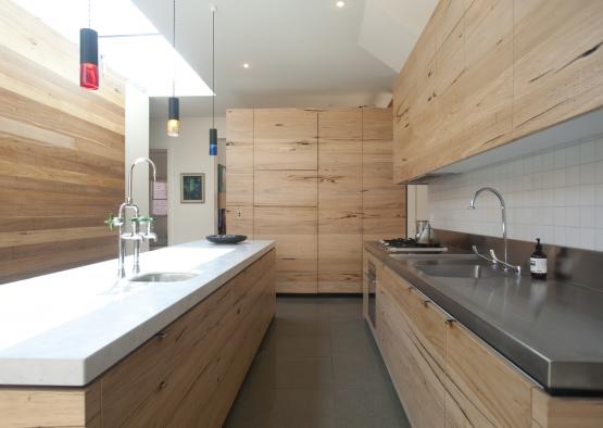 a kitchen with wood cabinets and sink