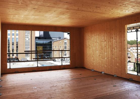 a room with a window and wood floor