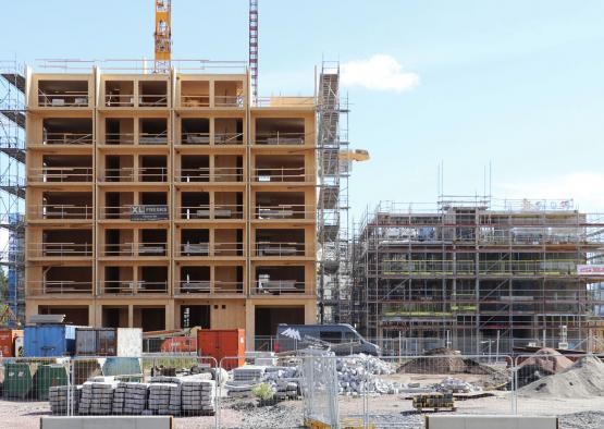 a construction site with a building and cranes