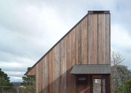 a wooden house with a glass door