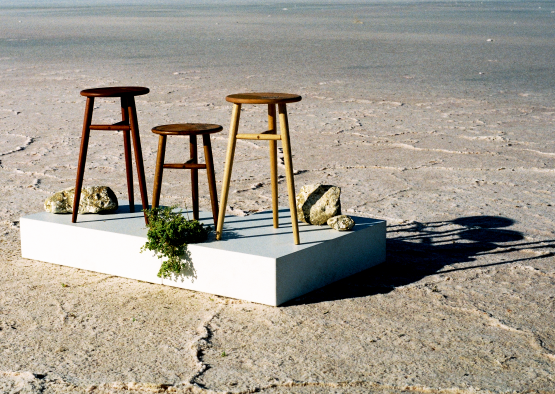 a group of stools on a white square platform