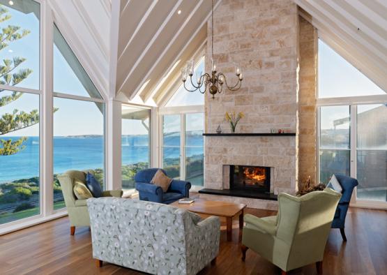 a living room with a fireplace and chairs