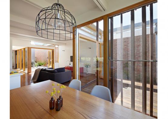 a dining table with a glass ceiling and a large glass door