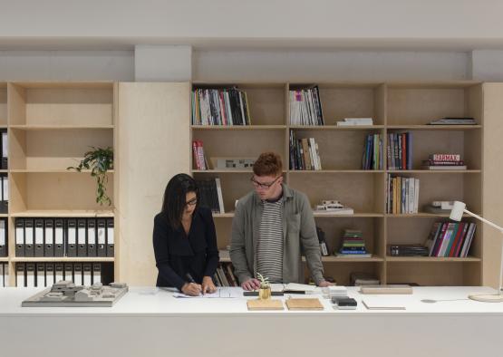 a man and woman standing at a desk