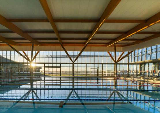 a large indoor swimming pool with a large glass wall