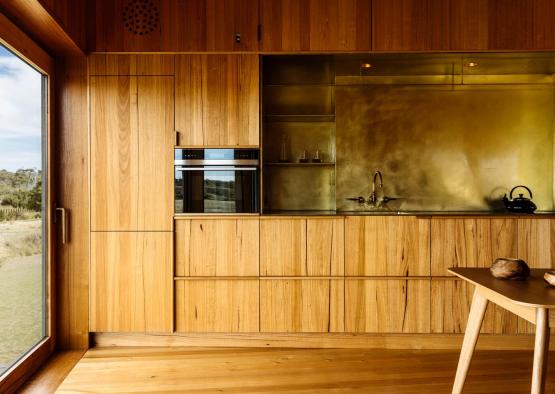 a kitchen with wood cabinets and a table