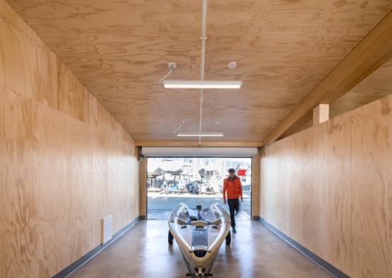 a man walking in a building with a boat