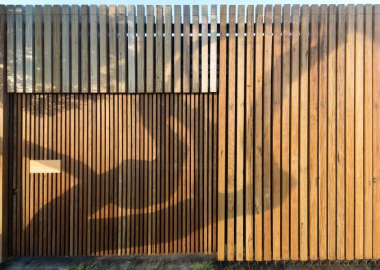 a wooden fence with a shadow of a person on it