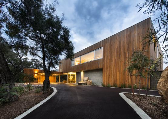 a house with a driveway and trees