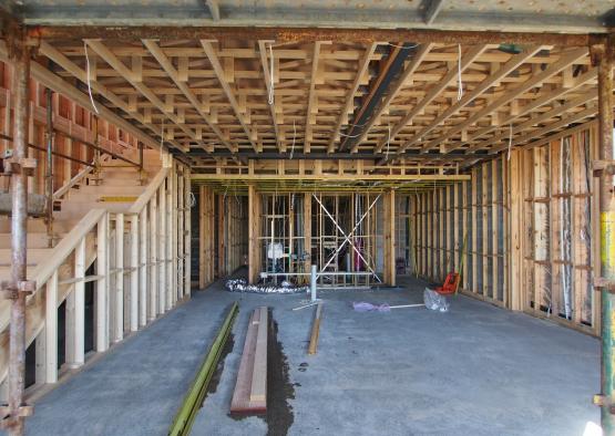 a building under construction with a beam and a metal frame