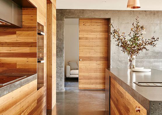 a kitchen with wood and concrete walls